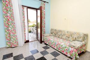 a living room with a couch and sliding glass doors at Apartments with a parking space Vantacici, Krk - 5386 in Malinska