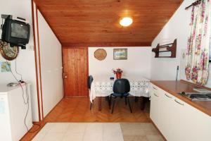 a kitchen and dining room with a table and chairs at Apartments with a parking space Vantacici, Krk - 5386 in Malinska
