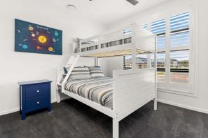 a bedroom with a white bunk bed and a window at The Manor in Cowes