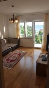 a living room with a couch and a rug at Apartments with a parking space Selce, Crikvenica - 5475 in Selce