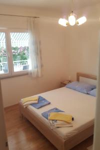 sypialnia z łóżkiem z dwoma ręcznikami w obiekcie Apartments with a parking space Selce, Crikvenica - 5475 w mieście Selce