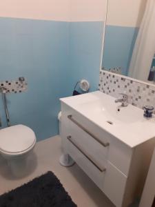 a bathroom with a sink and a toilet and a mirror at Apartments with WiFi Selce, Crikvenica - 5498 in Selce