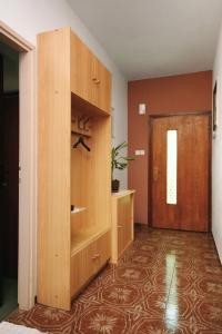 a large wooden cabinet in a room with a door at Apartments with WiFi Selce, Crikvenica - 5498 in Selce