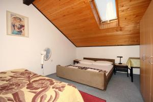 a bedroom with a bed and a wooden ceiling at Apartments with parking space Dramalj, Crikvenica - 5491 in Dramalj