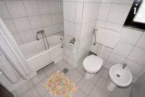 a bathroom with a toilet and a tub and a sink at Apartments with parking space Dramalj, Crikvenica - 5491 in Dramalj +32 photos