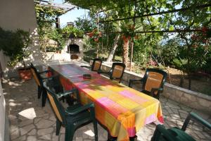 a colorful table and chairs on a patio at Apartments with parking space Dramalj, Crikvenica - 5491 in Dramalj
