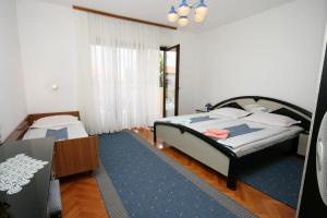 a bedroom with a bed and a blue rug at Apartments with a parking space Selce, Crikvenica - 5513 in Selce