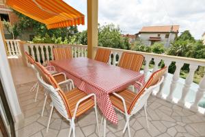 a table and chairs sitting on a balcony at Apartments with a parking space Selce, Crikvenica - 5513 in Selce