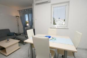 a living room with a white table and chairs at Apartment Pinezici 5464d in Pinezici