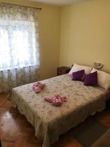 a bedroom with a bed with pink bows on it at Apartments with a parking space Smrika, Kraljevica - 5338 in Šmrika