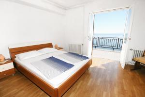 a bedroom with a bed and a view of the ocean at Apartments and rooms with parking space Stara Baska, Krk - 5447 in Stara Baška