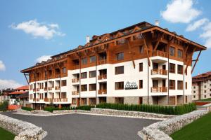 a large white building with a wooden roof at White Lavina - Ski, Bike, Hike in Bansko