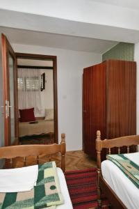 a bedroom with two beds and a mirror at Apartment Selce 5531b in Selce