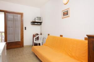 a bedroom with a bed and a tv on the wall at Apartments with a parking space Porat, Krk - 5322 in Malinska