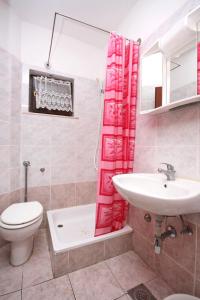 a bathroom with a sink and a toilet and a sink at Apartments with a parking space Porat, Krk - 5322 in Malinska +47 photos