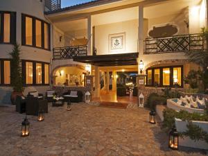 a large building with a courtyard with furniture and lights at Hotel Palau in Palau