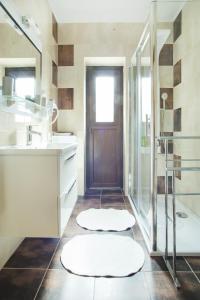 a bathroom with a sink and a shower and a door at Apartments with a parking space Malinska (Krk) - 5456 in Vantačići