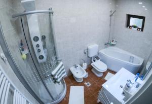a bathroom with a shower and a toilet and a sink at Apartments with a parking space Malinska (Krk) - 5456 in Vantačići +23 photos