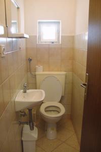 a bathroom with a toilet and a sink at Apartments with a parking space Baska, Krk - 5407 in Baška