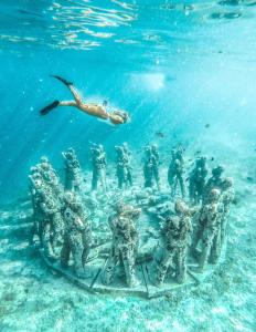 a group of soldiers in the water with a diver at Sasak Island Bungalows in Gili Meno