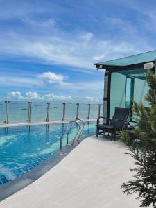 a swimming pool with a view of the ocean at Serenotel Pattaya in Pattaya Central
