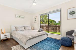 a bedroom with a bed and a large window at Panoscape in Sunset Strip