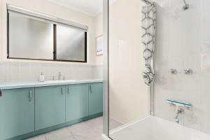 a bathroom with a sink and a shower at Panoscape in Sunset Strip +4 photos