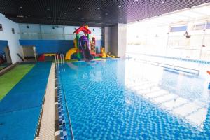 a large swimming pool with a water slide at Pooh House 7 - 3 bedrooms with city view in Vung Tau