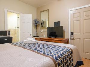 Ένα ή περισσότερα κρεβάτια σε δωμάτιο στο Elite Inn