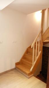 a staircase in a living room with wooden floors at Gite Notre Dame in Pontorson