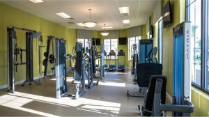 a gym with lots of equipment in a room at "Violet Love & Magic" Luxury Villa Storey Lake in Kissimmee