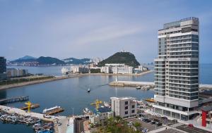 a large building next to a body of water at Citadines Connect Hari Busan in Busan