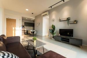 a living room with a couch and a flat screen tv at Conezion Residence Putrajaya 3BR6Pax IOI City Mall in Putrajaya