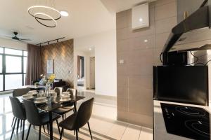 a kitchen and dining room with a table and chairs at Conezion Residence Putrajaya 3BR6Pax IOI City Mall in Putrajaya