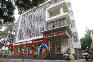 a building with a store in front of it at Hotel Dwarka Grand in Aurangabad