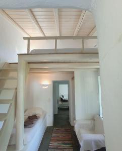 a room with a loft bed and a staircase at Red Tractor Farm in Korissia