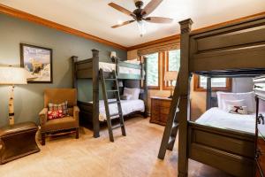 a bedroom with two bunk beds and a chair at Strawberry Park Ski-in Ski-Out Condo Close to Chairlift in Beaver Creek