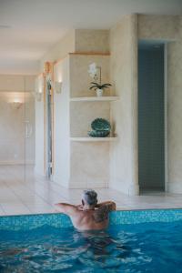 a man swimming in a swimming pool at Hotel Tobler in Ascona