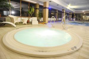 a large swimming pool with a large mirror at Hotel Mir-Jan SPA in Lądek-Zdrój