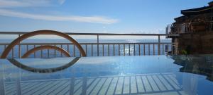 a swimming pool with a view of the ocean at Relaxing Paradise Chez Nicolini in Erbalunga