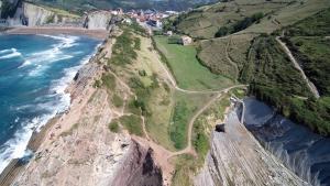 an aerial view of the cliffs next to the ocean at Kampaoh Zumaia in Zumaia
