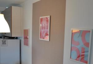 a kitchen with three pictures on the wall and a refrigerator at großes offenes Loft oder kleine gemütliche Wohnung mit Balkon in Wolmirstedt