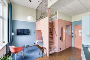 a small room with a staircase and a desk and chair at Forenom Aparthotel Malmö Varvsstaden in Malmö