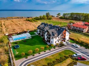 an aerial view of a large house with a yard at Perla Mare Apartamenty in Krynica Morska
