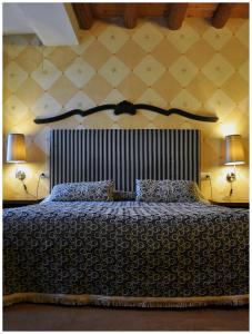 a bedroom with a large bed with two lamps at Casa Magnani in Verona