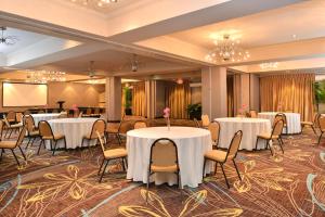 una sala de banquetes con mesas y sillas y una pantalla de proyección en Holiday Inn Express Hotel & Suites Dallas South - DeSoto, an IHG Hotel en DeSoto