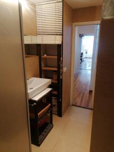 a bathroom with a sink and a door to a hallway at Apartamento con encanto Mila VALENCIAYOLE in Valencia