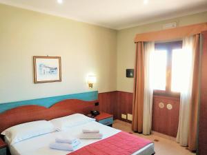 Postel nebo postele na pokoji v ubytování Hotel Riviera Fiumicino
