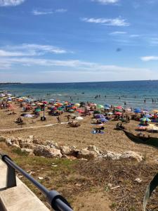 a group of people on a beach with umbrellas at CASA ARUCI in Avola