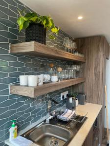 a kitchen with a sink and a counter top at Tinswari Self-catering Chalet in Hluhluwe